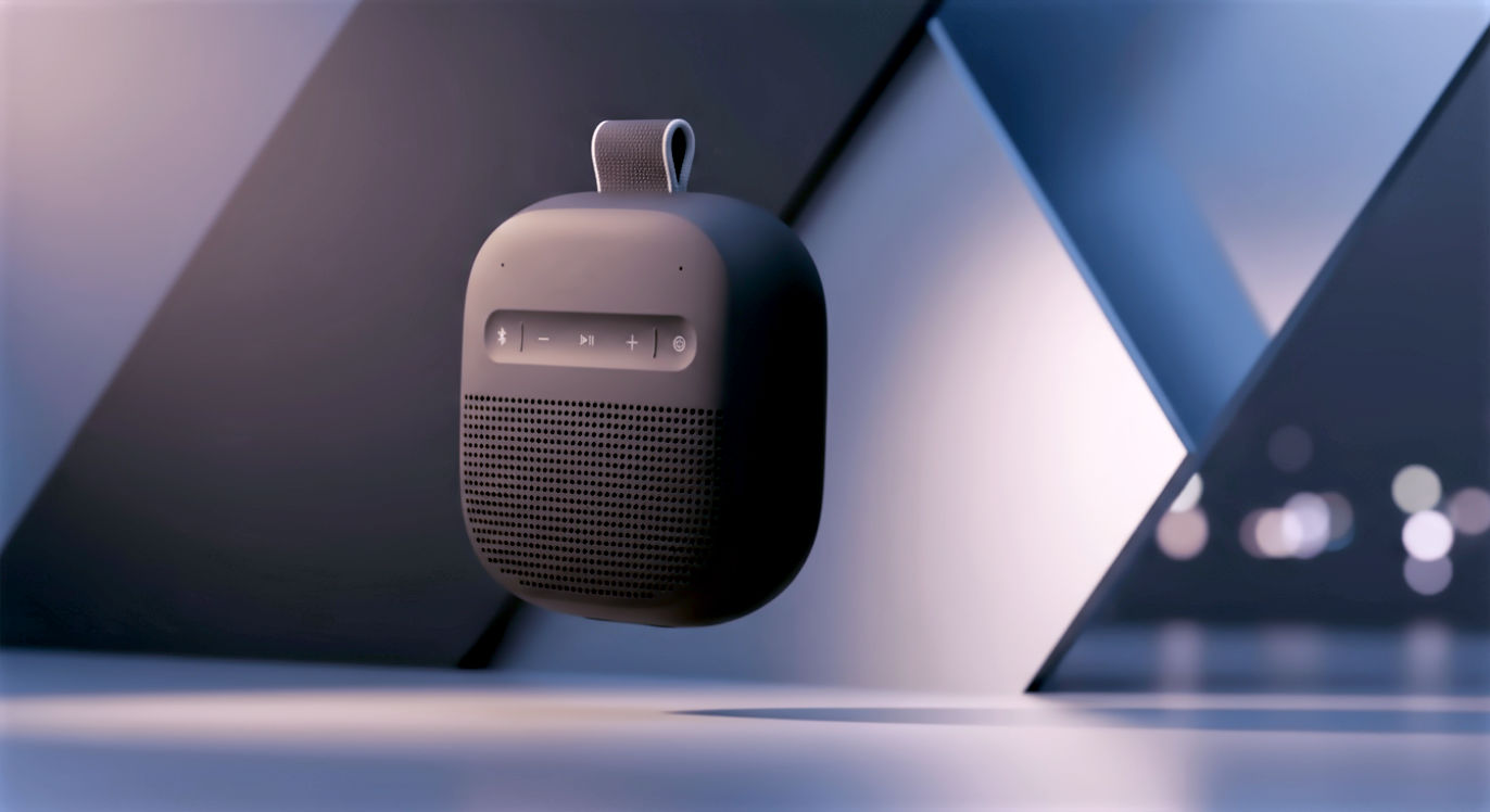 Imagine a compact, portable Bluetooth speaker shaped like a soft-edged rectangular prism—more square than tall, evoking the proportions of a small bar of soap or a matchbox that's been gently sanded down.